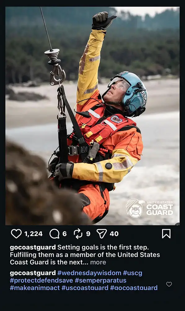 rescue swimmer being hoisted up wearing a harness